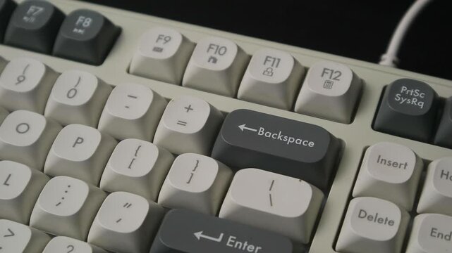 Close-up of a Finger Pressing Backspace Key on a Retro Mechanical Keyboard