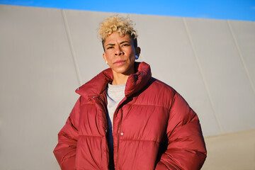 headshot of serious woman standing outdoors wearing winter jacket © Cristina Garcia