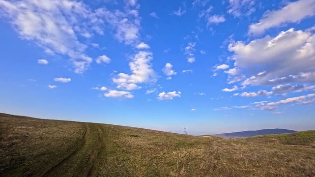 Dirt Road Trail Through Hills in Bulgarian Countryside at Sunset, Scenic Nature Landscape With Blue Sky and Rural Path, Mountain Meadow Panorama in Bulgaria, Outdoor Travel Destination, Peaceful