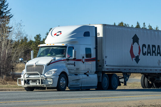 Quebec, Canada, 24 April 2026 : A white Caratrans International semi truck travels on a highway, transporting goods.