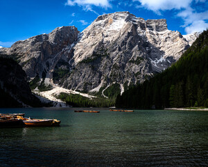Traditional Wooden Rowing Boats on Lago di Braies with Snow-Capped Dolomite Peaks, Italy © Nussbaumer