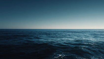 Obraz premium Vast Ocean Horizon Under a Clear Blue Sky.