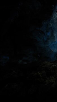 A bright light enters the cave from the outside. The rocks are dark and wet. The light creates a colorful glow on the cave walls. Clouds can be seen in the sky.