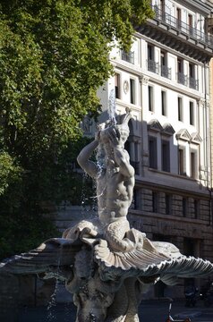 Rome, Italy 09.05.2020: 17th century Fontana del Tritone (Triton Fountain) with dolphins heads, located in the Piazza Barberini, Rome, Italy