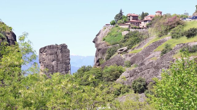 monastery of agios stefanos perched on a massive conglomerate rock pillar in meteora greece, a stunning unesco world heritage site with panoramic mountain views