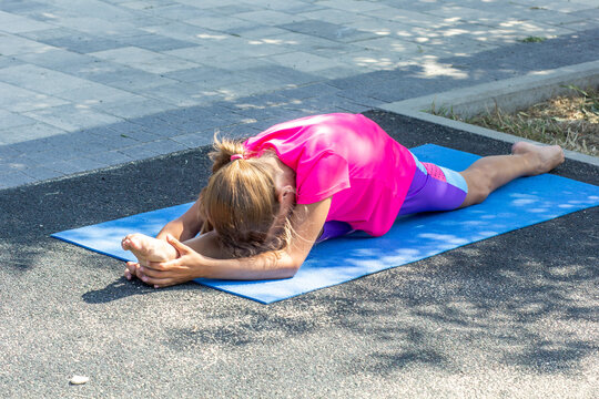 Child stretched forward in a front split pose