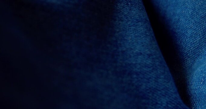 Close-up video of rumpled denim fabric.Abstract background.