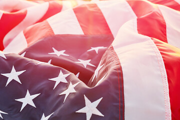 American flag closeup with waving fabric in sunlight, patriotic USA background for Independence Day, Memorial Day or national celebration concept