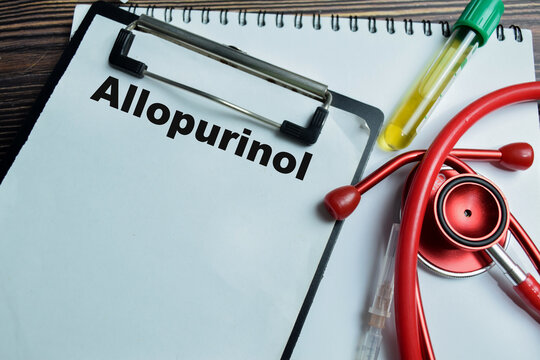 Concept of allopurinol write on clipboard isolated on Wooden Table.