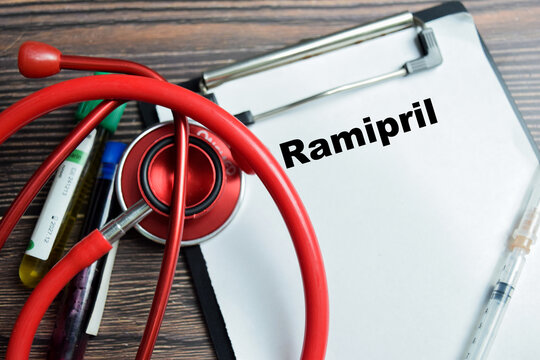 Concept of ramipril write on clipboard isolated on Wooden Table.
