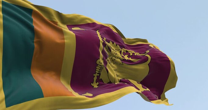 Sri Lanka national flag waving on a clear day. Green and orange stripes, amaranth panel with yellow lion, sword, Ficus religiosa leaves. Seamless 3d render animation. Slow motion loop. Selective focus
