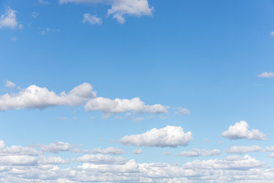 Soft white clouds in a gentle blue autumn sky over the Severn Vale near Coombe Hill, Gloucestershire, England UK