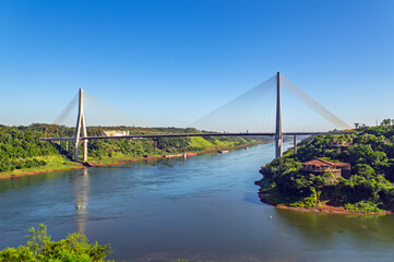 Obraz premium The Integration Bridge, a massive cable-stayed structure crossing the Parana River between Foz do Iguacu, Brazil and Presidente Franco, Paraguay