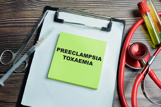 Concept of preeclampsia toxaemia write on sticky notes isolated on Wooden Table. A multi-system disorder during pregnancy including high blood pressure and proteinuria