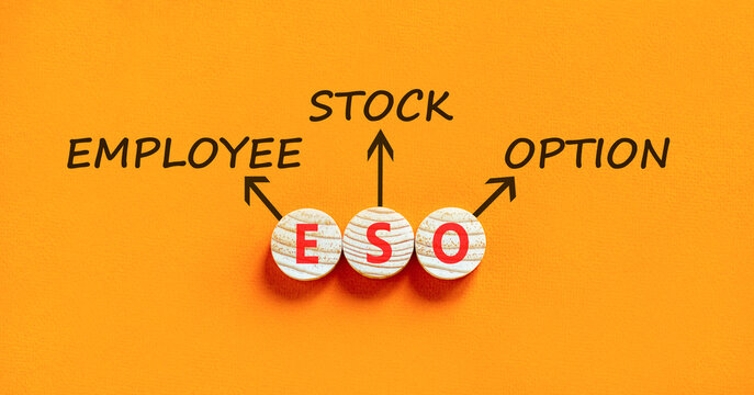 ESO employee stock option symbol. Concept words ESO employee stock option on beautiful wooden circles. Beautiful orange background. Business ESO employee stock option concept. Copy space.