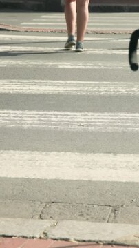 Vertical video: Stepping on stripe woman white dress walking to curb rider pushing pink bike behind