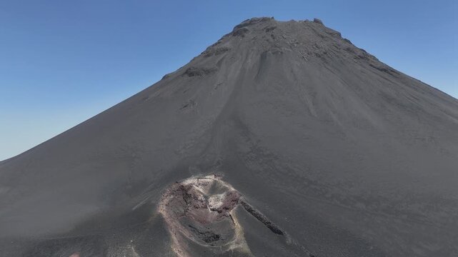Aerial shot of Pico do Fogo volcano, Cabo Verde, main slope and a dramatic foreground volcanic vent. A striking display of raw geological power and barren terrain