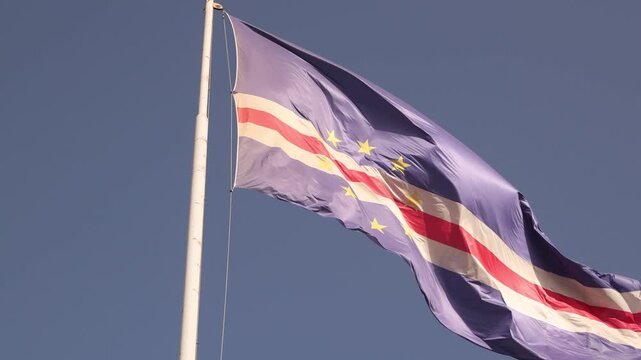 The national flag of Cabo Verde in the wind, patriotism and independence in the Atlantic archipelago, close up