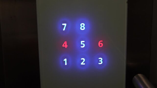 Someone is pressing the elevator button to go up the building.