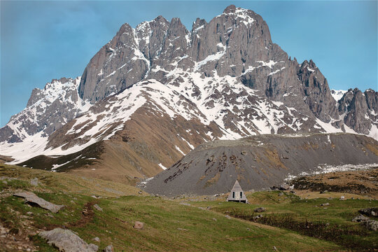 Atmospheric mountain scenery featuring a solitary A-frame structure