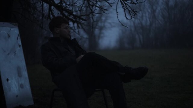 A lonely man smokes in a courtyard at dusk, an arthouse mystical scene