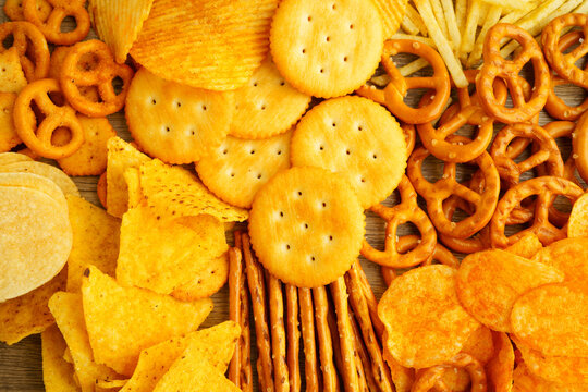 Mix of variety snack chips pretzel and cracker, junk crunchy food.