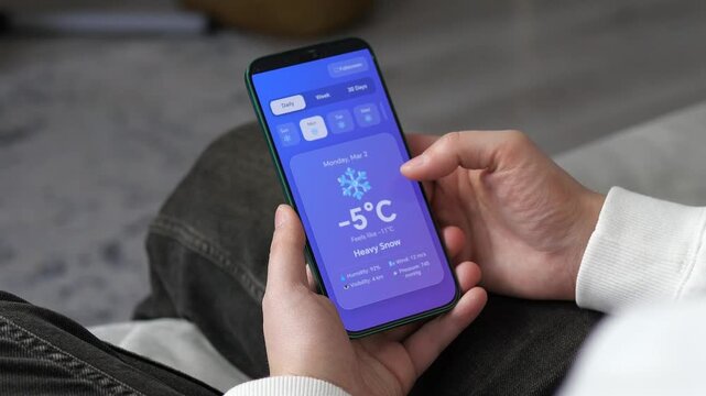 Monitoring sub-zero temperatures and snow alerts on a mobile screen. Realistic winter weather monitoring via a digital app. Great for seasonal marketing, environmental news, and smart technology