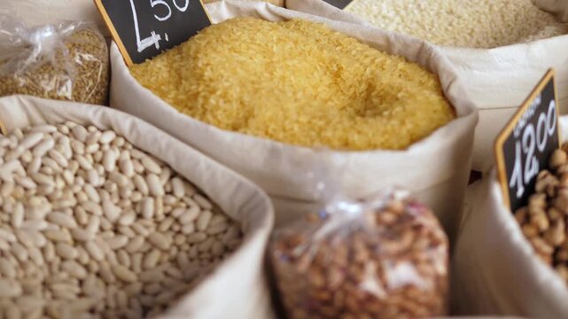 Traditional Italian market display with dried fava beans and rice, key ingredients in many regional home-style recipes.