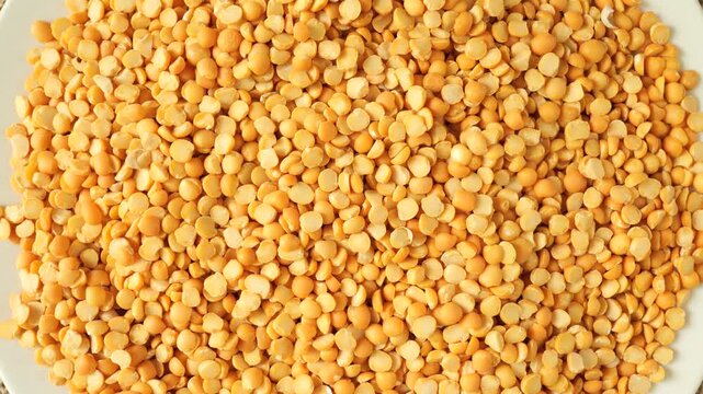 Dry yellow split peas rotating slowly