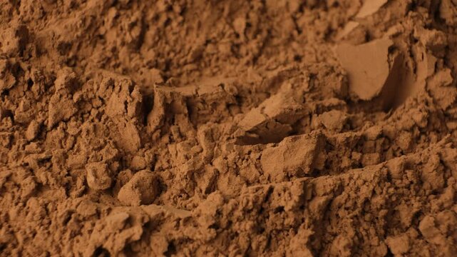 Raw organic cocoa powder texture background rotating