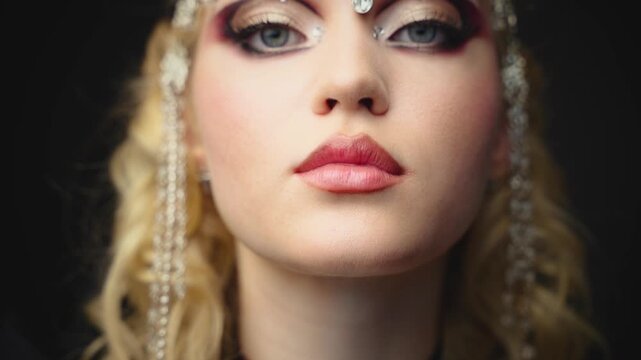 Fantasy girl portrait dark queen woman beautiful face with art creative graphic make-up blue green eyes, luxury elf girl, black veil hood on head blonde long hair silver jewelry tiara crown diamonds.
