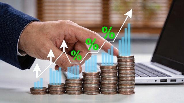 Business hand touching rising financial graph with coins stacks and percentage symbols, representing investment growth, profit increase, economic success, wealth accumulation,