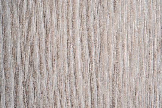 Macro texture of artificial wood grain furniture facade material. Decorative synthetic surface for interior design.