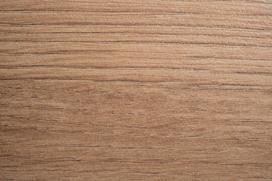 Macro texture of artificial wood grain furniture facade material. Decorative synthetic surface for interior design.