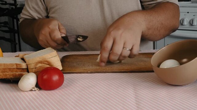 A man prepares a salad with tuna and egg