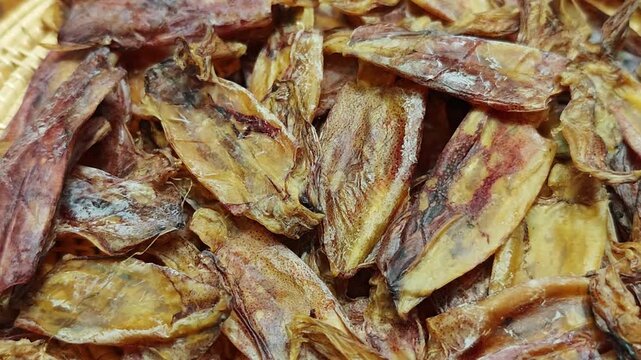 Dried squid on a basket.