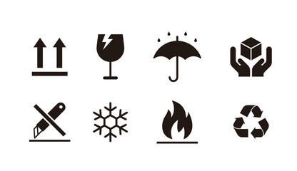 Set of packaging and shipping symbols for cargo handling. Black icons including fragile, keep dry, this side up, flammable, and recycle signs for warehouse logistics and product packaging design. © Tuesday04