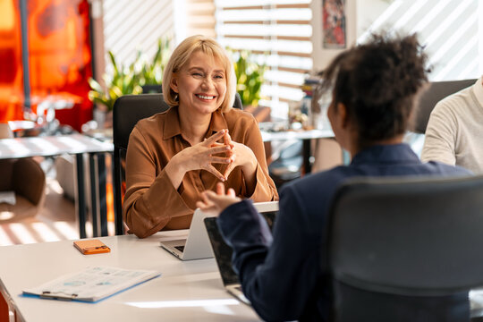 Smiling manager interviewing job candidate at office meeting