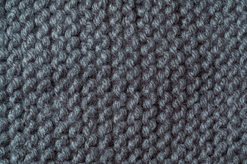 Naklejka premium Close-up texture of dark gray knitted fabric with visible yarn loops