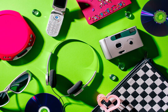 Top view of vintage gadgets and fashion accessories for 2000s nostalgia