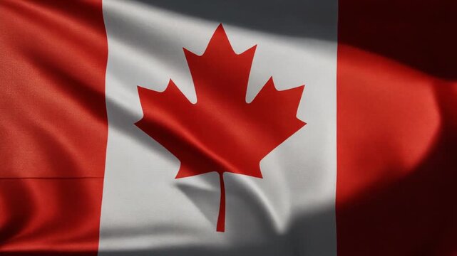 Red and White Maple Leaf Flag Waving in Sunlight with Rippling Fabric Texture