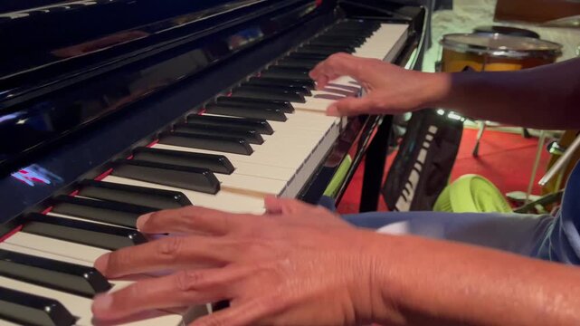 Detailed close-up of hands performing on a grand piano during a live music session, capturing rhythm, emotion and artistic performance in an intimate setting