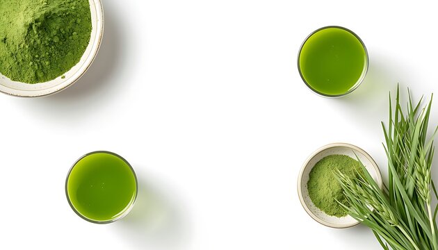 Fresh matcha green tea powder displayed with bowls of prepared tea and fresh wheatgrass sprigs on a clean surface