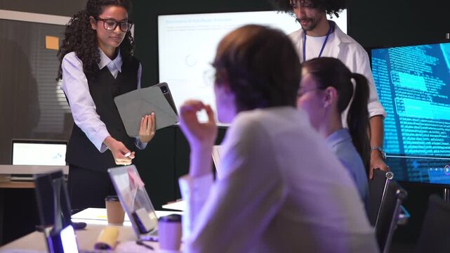 Tech team participating in an AI safety workshop, sharing notes on a clipboard regarding AGI deployment and neural network optimization.