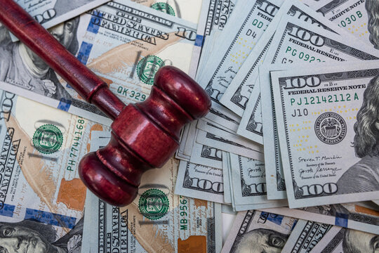 Close up of Gavel on Hundred Dollar Bills for Financial Crime Investigation and Corruption Concept