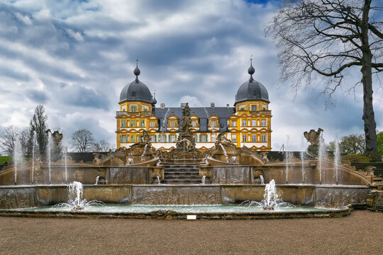 Front view of Schloss Seehof with fountain in Memmelsdorf Germany. Baroque palace facade under cloudy sky