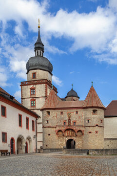 View of Scherenberg Gate at Marienberg Fortress in Wurzburg Germany. Medieval stone gatehouse under partly cloudy sky