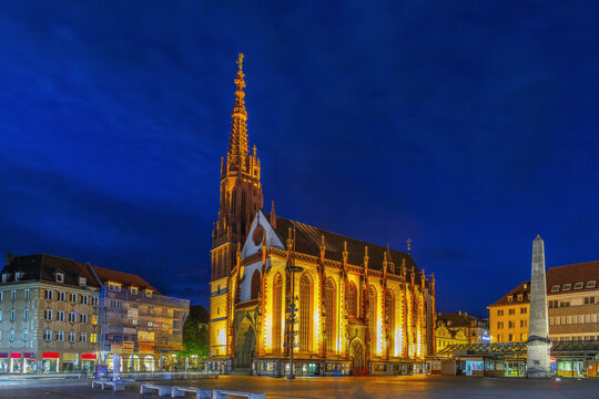 Night view of Marienkapelle with market square in Wurzburg Germany. Illuminated Gothic church facade under dark evening sky