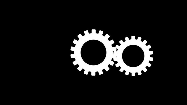 Two interlocking white gears on a black background representing teamwork industry and mechanics.4k