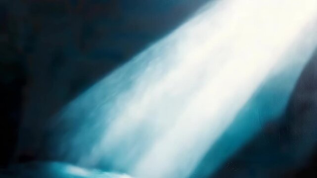 Bright rays of light enter a dark area, casting strong patterns on nearby surfaces. The movement of light changes the look as time goes by, creating interesting visuals